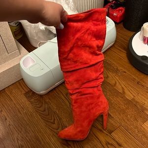 Knee high red high heeled boots